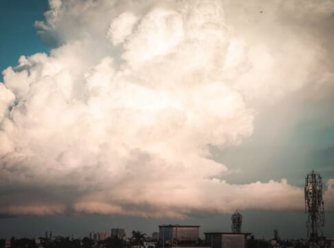 Stunning cumulus clouds towering over the urban skyline of Kolkata, creating a dramatic scene.