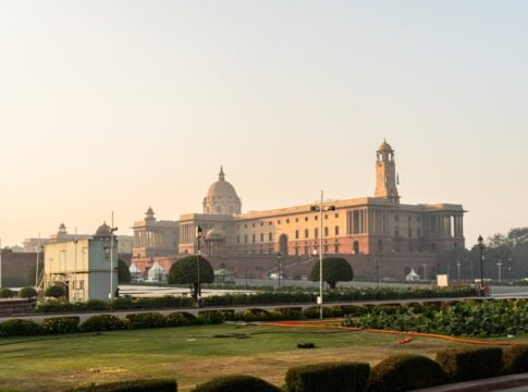 Stunning view of Rashtrapati Bhavan with a clear sky in New Delhi, India, during sunrise.