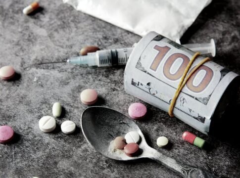 Symbolic representation of drug addiction and financial cost with pills and money. Symbolic representation of drug addiction and financial cost with pills and money.