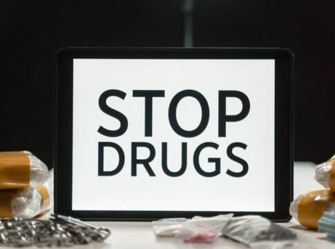 Tablet screen displaying anti-drug message surrounded by packaged substances, promoting awareness.