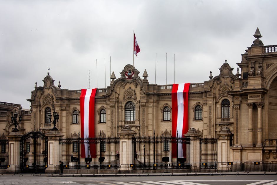 Peru Votes in Presidential Election Amidst Political Turmoil and Record Candidate Field The Presidential Palace in Lima, Peru, with vibrant red and white flags displayed on the facade.
