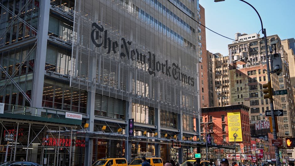 The iconic New York Times building with yellow taxis in bustling Manhattan.