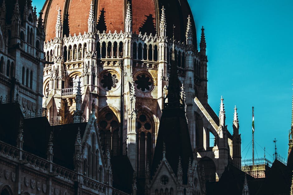 The iconic dome of the Hungarian Parliament Building in Budapest, bathed in sunlight.