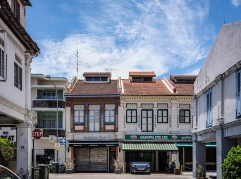 Traditional shophouses under a vibrant sky, depicting Singapore's cultural architecture.