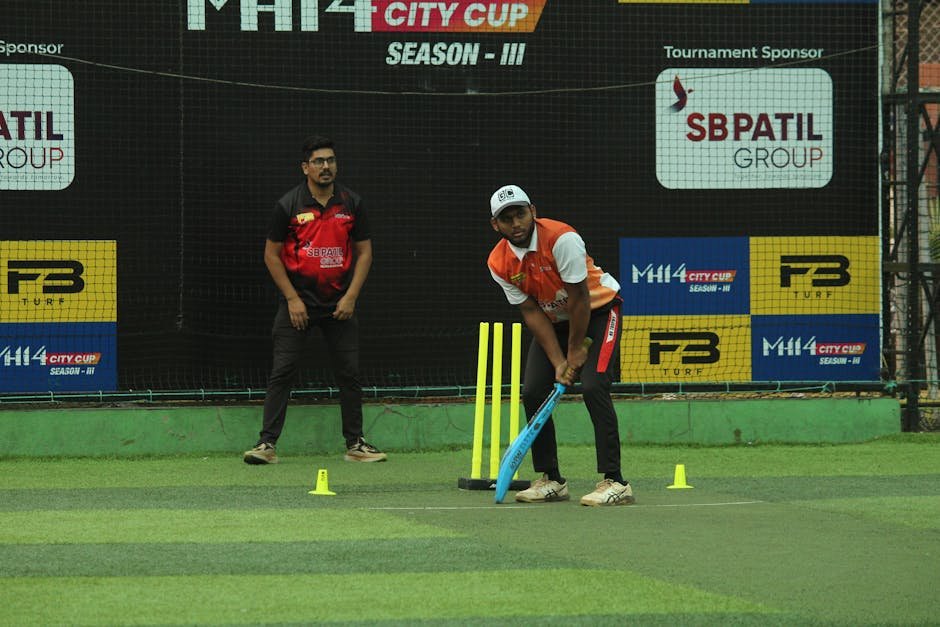 Punjab Selects 250 Players for Four Hockey Residential Wings Two cricket players on a turf field during the MH14 City Cup Season III match.