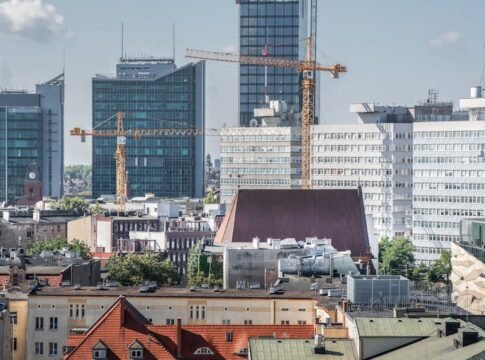 Urban skyline of Poznań with cranes and modern architecture in view. Urban skyline of Poznań with cranes and modern architecture in view.