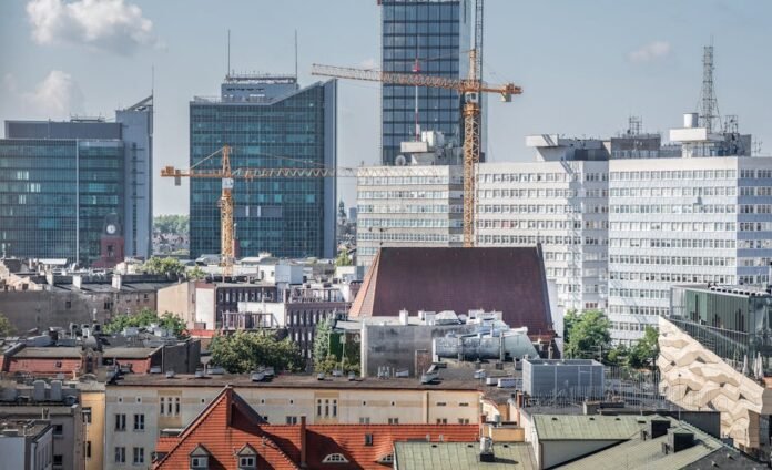 Urban skyline of Poznań with cranes and modern architecture in view. Urban skyline of Poznań with cranes and modern architecture in view.