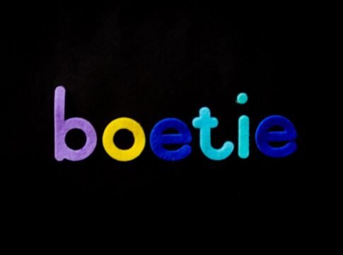 Vibrant, colorful letters forming 'boetie' on a black background.