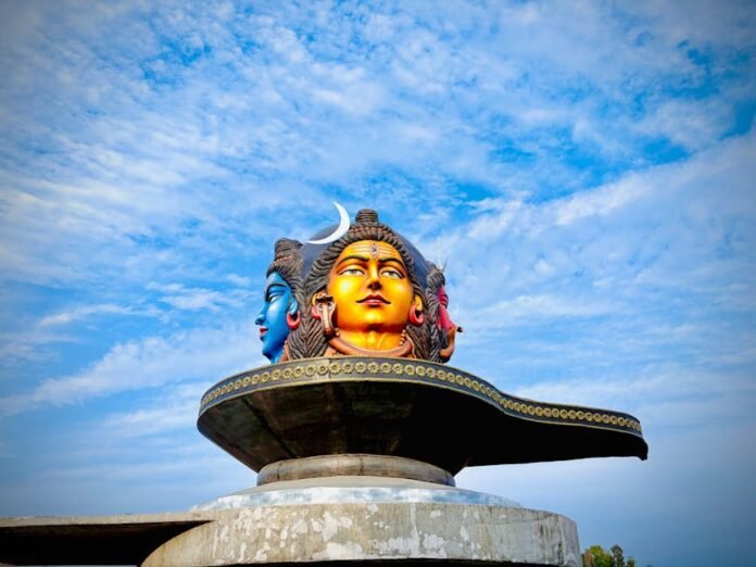 Vibrant three-headed Shiva statue under a blue sky in Pokhara, Nepal. Vibrant three-headed Shiva statue under a blue sky in Pokhara, Nepal.