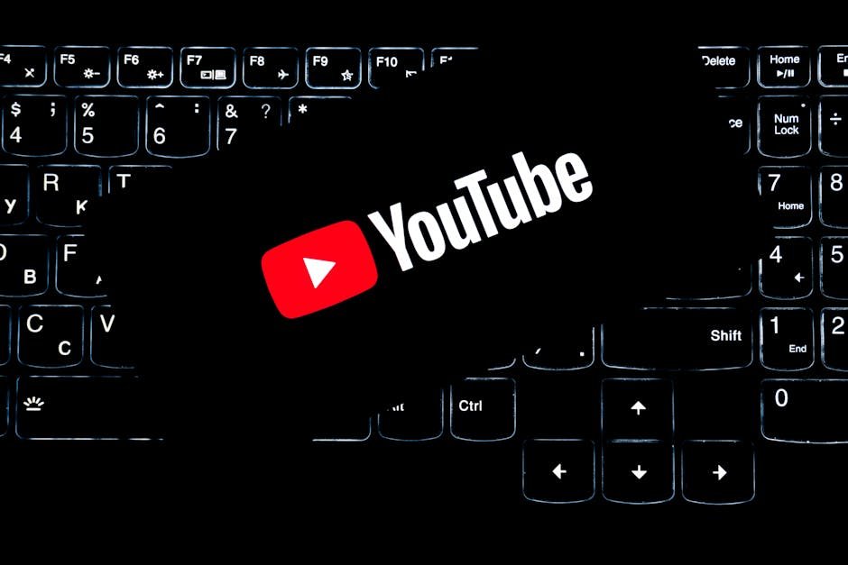 YouTube logo displayed on a backlit keyboard, representing digital media and online content creation.