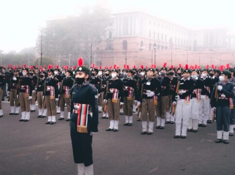A large group of soldiers in uniform standing in formation during a military parade outdoors. A large group of soldiers in uniform standing in formation during a military parade outdoors.