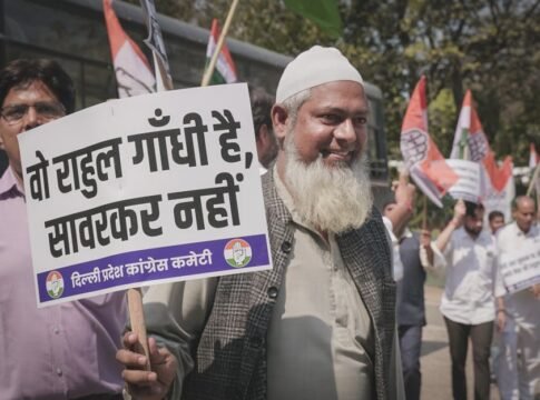 A man participates in a street protest holding a sign with political messaging.