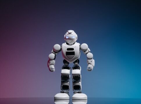 A modern toy robot standing on a gradient background, showcasing innovation and technology. A modern toy robot standing on a gradient background, showcasing innovation and technology.