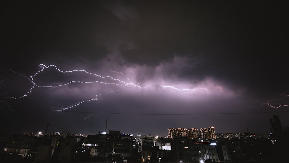 A striking lightning storm illuminates the night sky over an urban cityscape, capturing the power of nature.