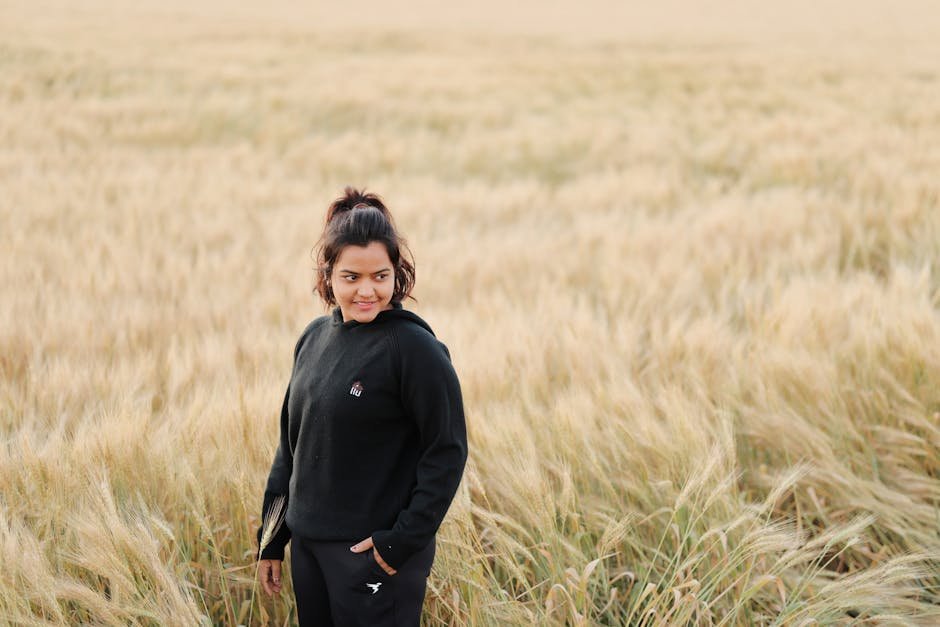 Delhi High Court Denies Vinesh Phogat Immediate Relief in Asian Games Trials Plea A young woman stands in a golden wheat field enjoying a sunny day. Perfect for rural lifestyle and nature themes.