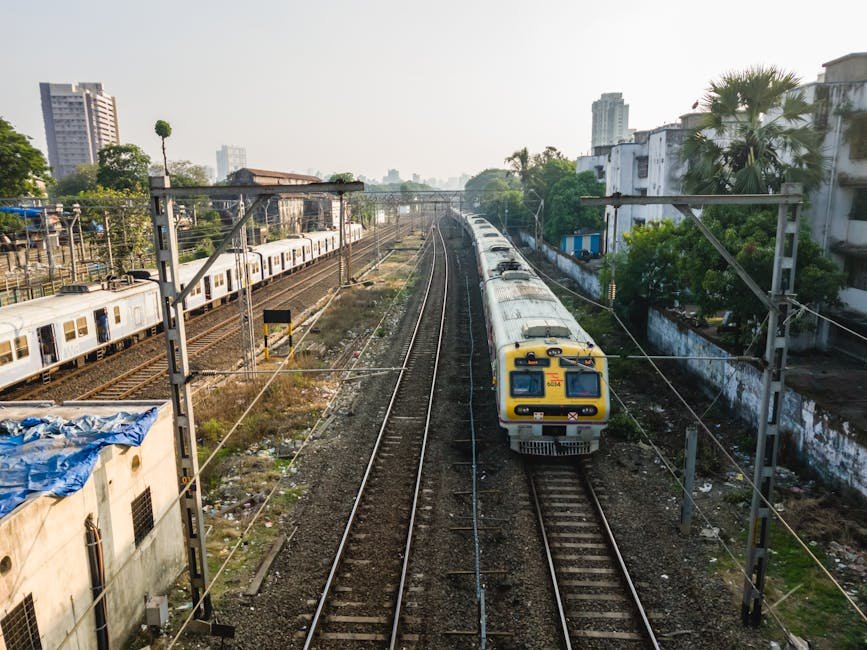 Aerial view of trains on tracks at a railway station in Mumbai, India.