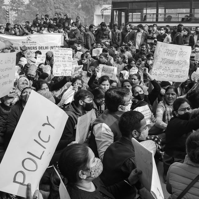 NSUI Protests DD News Anchor at Delhi University Book Launch Black and white image of a crowded protest rally in Delhi advocating for policy reform.