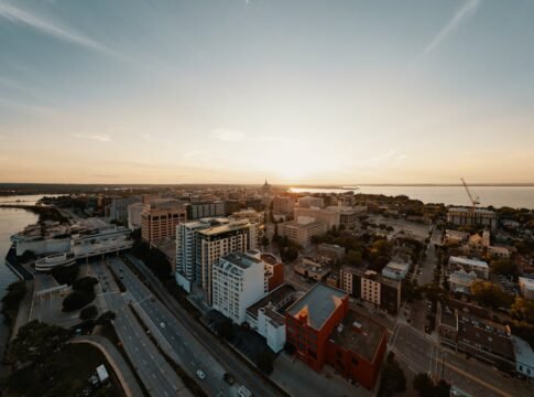 Breathtaking aerial view of Madison, Wisconsin's cityscape during a serene sunset.