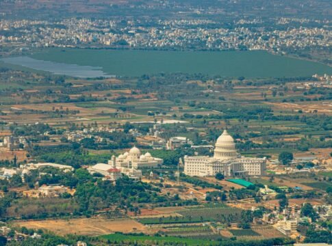 Breathtaking aerial view of lush landscapes and architecture near Nandi Hills, Karnataka, India.