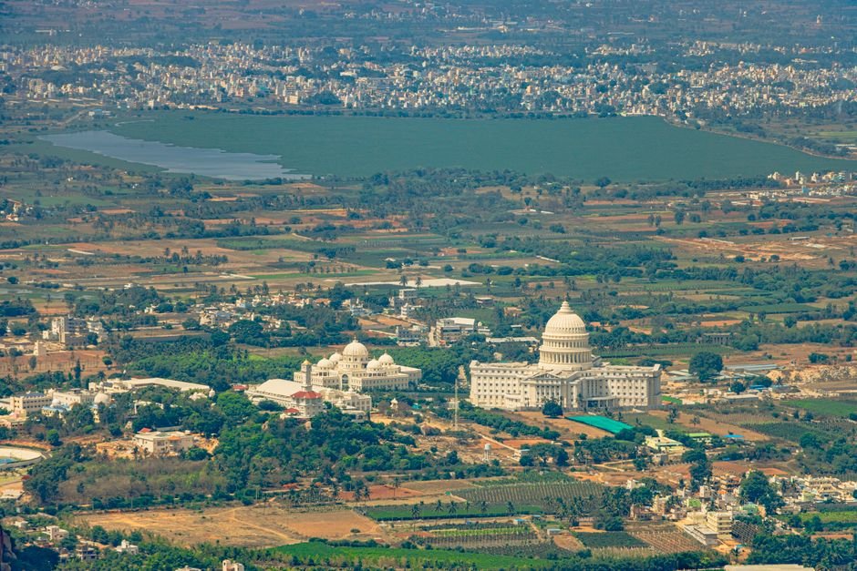 Andhra Pradesh’s Puttaparthi Receives ₹136 Crore Drinking Water Project Breathtaking aerial view of lush landscapes and architecture near Nandi Hills, Karnataka, India.