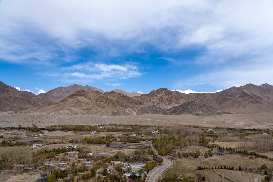 Ladakh LG Approves New Excise Policy to Curb Drug Abuse, Boost Tourism Breathtaking landscape of Leh with majestic mountains and serene valley under a vibrant sky.