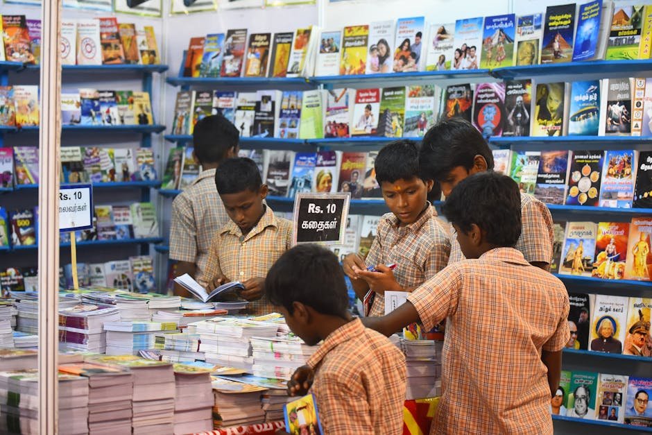 Tamil Nadu Achieves 94.31% Pass Rate in Class 10 Board Exams Children engaged in browsing books at a stall in Madurai, highlighting interest in reading and education.