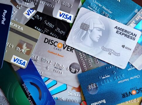 Close-up image of various credit cards including Visa, Mastercard, and American Express.