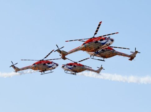 Colorful helicopters performing impressive aerobatic maneuvers in clear skies. Colorful helicopters performing impressive aerobatic maneuvers in clear skies.