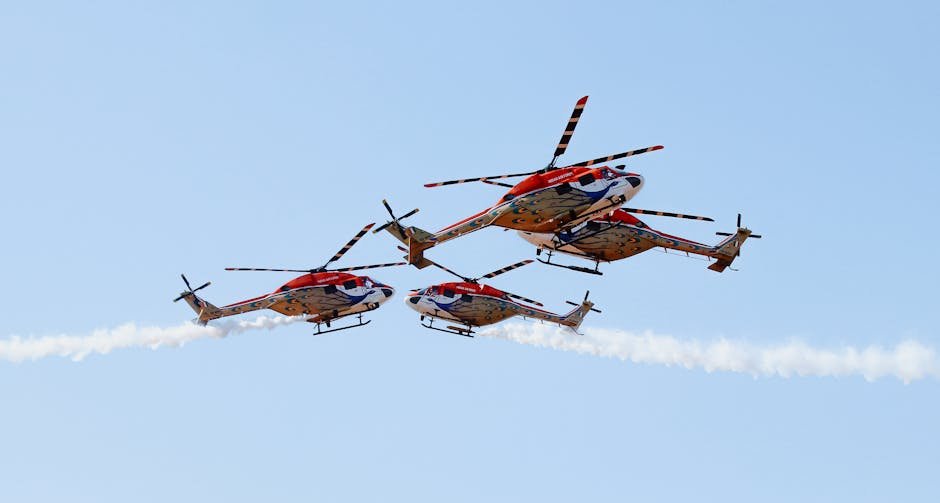 IAF’s Sarang Team Enhances Aerobatic Repertoire with Five-Helicopter Formations Colorful helicopters performing impressive aerobatic maneuvers in clear skies.