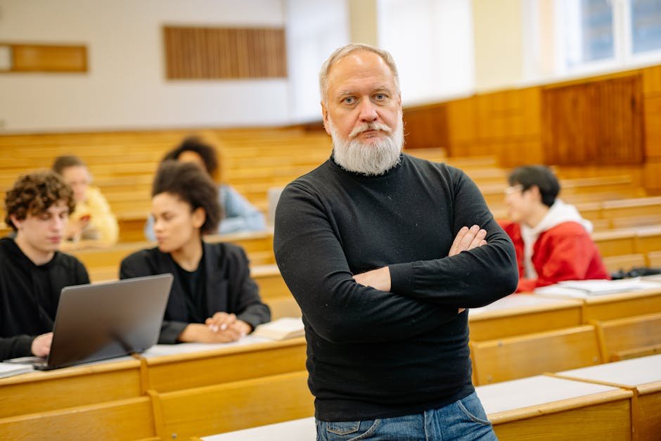Chennai Faces Increased Competition for B.Com Seats; Computer Courses Emerge as Popular Alternative Confident professor in lecture hall with diverse students engaged in learning.