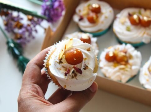 Delicious cupcake topped with Gulab Jamun and cream, perfect for dessert lovers.