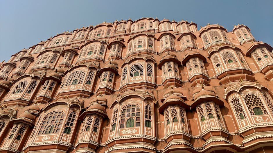Detailed view of Hawa Mahal architecture with intricate windows in Jaipur, India.