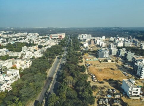 Drone shot capturing the expansive urban landscape and development in Gurugram, India.