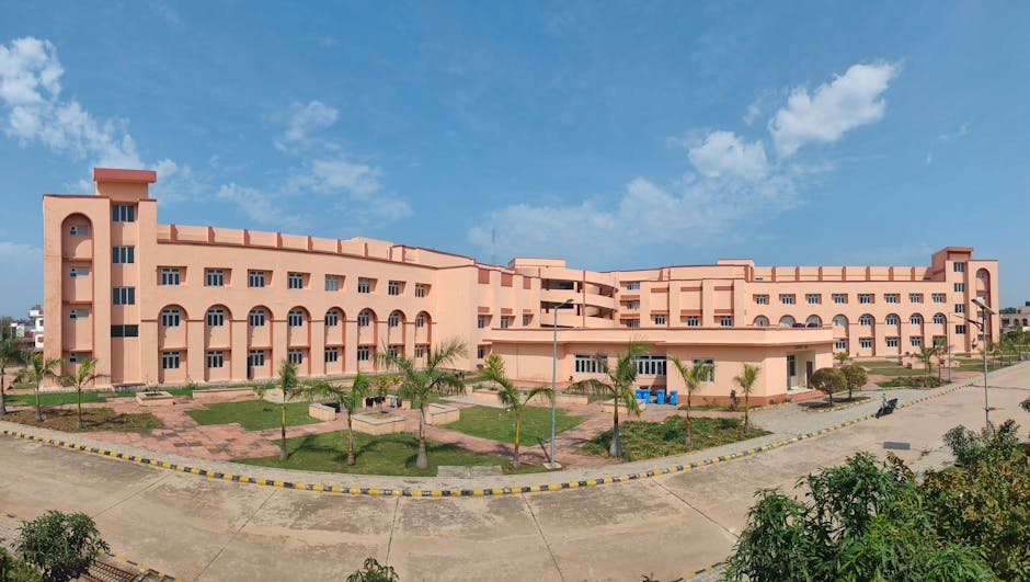 Odisha’s NIT Rourkela Introduces New Programmes in AI, Semiconductors Large educational building with clear blue sky and landscaped grounds.