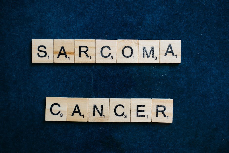 Delhi Hospital Successfully Treats Teenager Battling Rare Bone Cancer Sarcoma cancer awareness displayed using Scrabble tiles on a dark blue background.