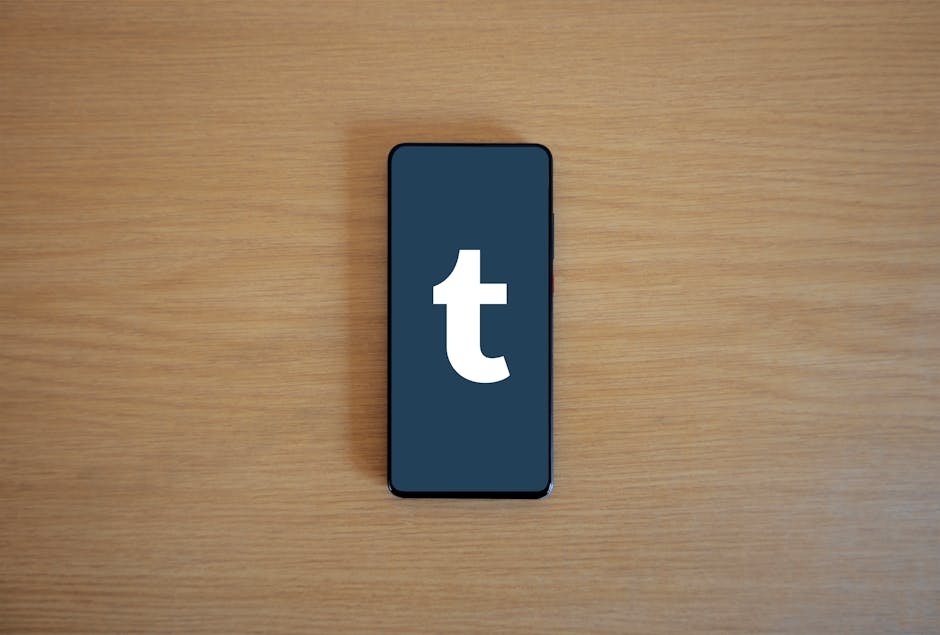 Smartphone displaying app logo on a wooden table, perfect for tech and lifestyle themes.