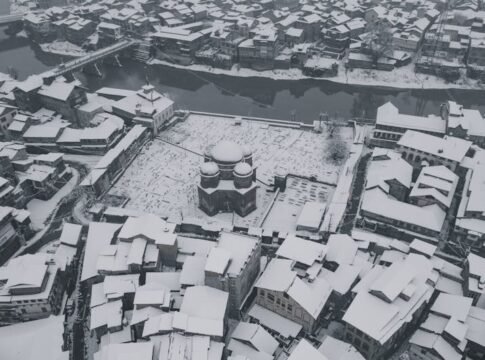 Stunning aerial view of snow-covered Srinagar, showcasing its winter charm and urban landscape.