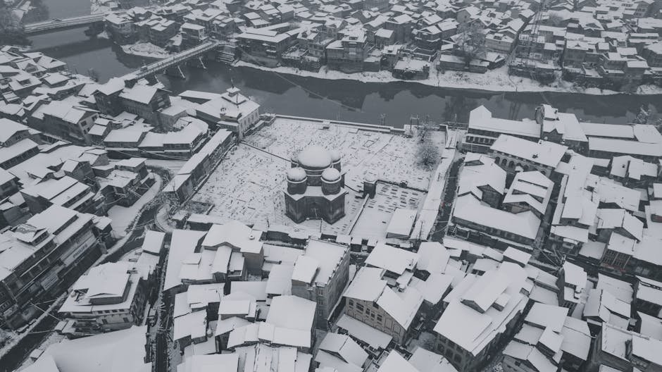 Stunning aerial view of snow-covered Srinagar, showcasing its winter charm and urban landscape.