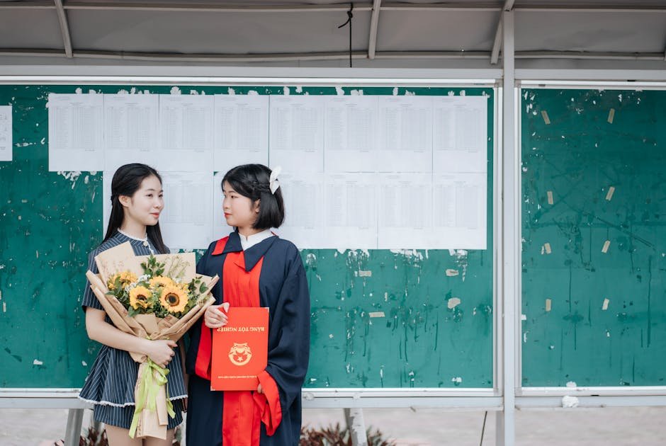 Tamil Nadu Declares SSLC Class 10 Results with 94.31% Pass Rate Two graduates celebrate in front of a bulletin board with a sunflower bouquet and diploma.