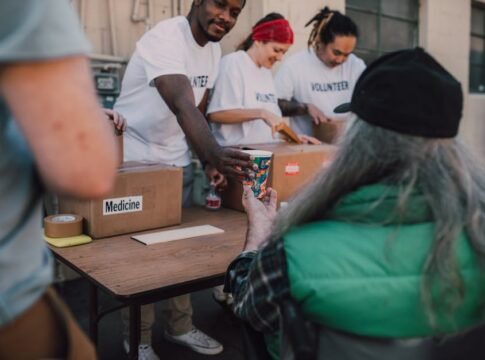 Volunteers handing out donations and support to those in need at a community event.