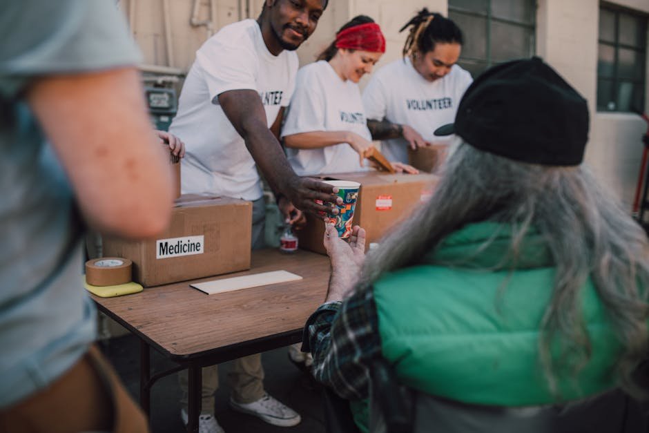 Jammu and Kashmir: Voluntary Medicare Society Aids Thousands in Rehabilitation Volunteers handing out donations and support to those in need at a community event.