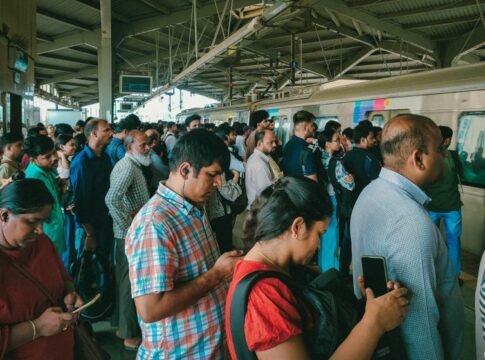 A bustling scene of commuters waiting on a Mumbai train station platform. Captures Mumbai's daily life.