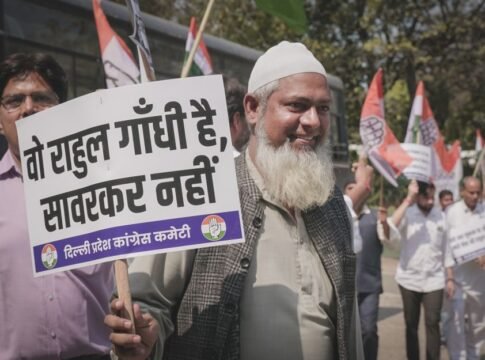 A man participates in a street protest holding a sign with political messaging.