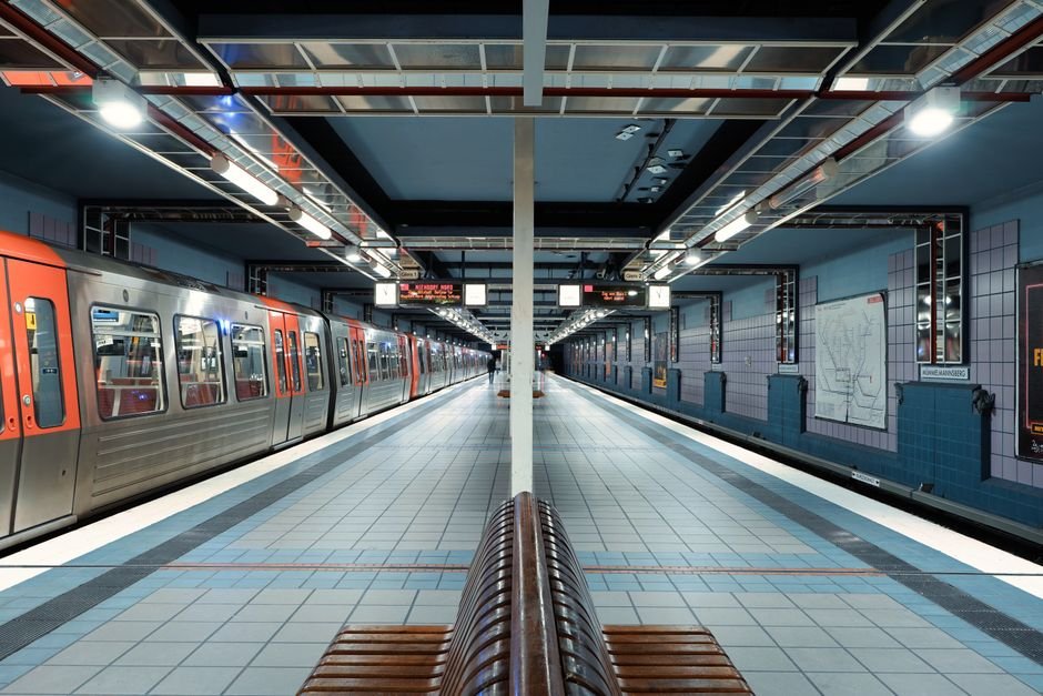 A quiet and modern subway station in Hamburg, showcasing sleek architecture and trains.