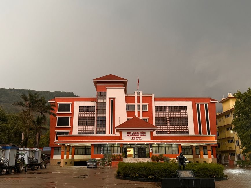 Maharashtra Government Enhances Scrutiny for New Infrastructure Projects to Curb Cost Escalation A striking red government building stands under an overcast sky, featuring modern architecture.