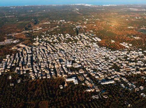 A stunning aerial view of Fasano, Apulia, Italy, showcasing urban and rural landscapes.