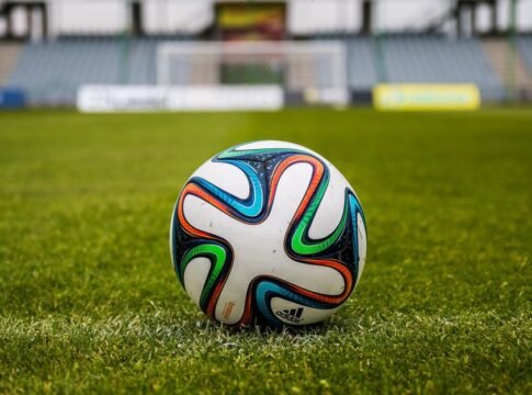 A vibrant adidas soccer ball on a green field, perfect for sports enthusiasts. A vibrant adidas soccer ball on a green field, perfect for sports enthusiasts.