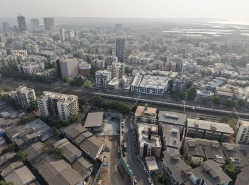 Aerial shot of Mumbai showcasing a sprawling urban landscape with dense architecture. Aerial shot of Mumbai showcasing a sprawling urban landscape with dense architecture.