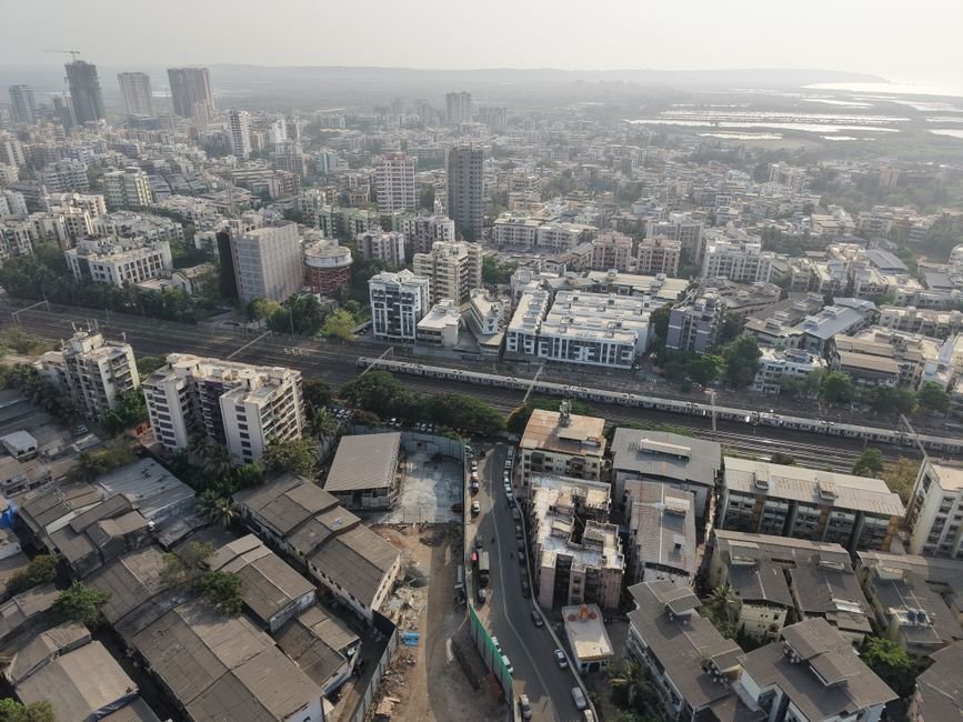 Mumbai’s BKC Sees Modest Traffic Dip During Inaugural ‘Public Transport Friday’, Last-Mile Gaps Highlighted Aerial shot of Mumbai showcasing a sprawling urban landscape with dense architecture.