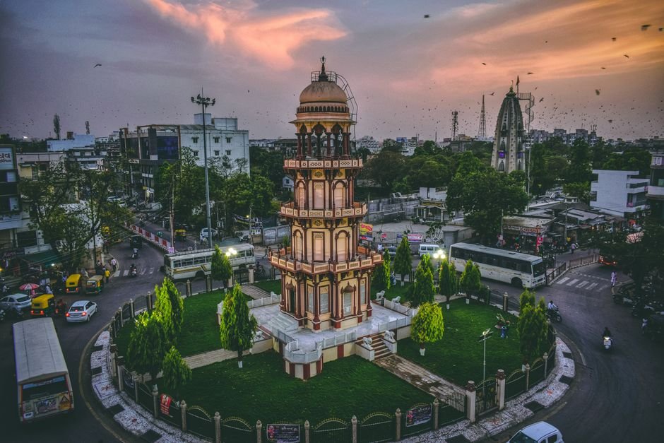 Maharashtra Cabinet Approves ₹300 Crore Medical Cyclotron Facility in Nagpur Aerial view of a historic tower in Ahmedabad, India at dusk surrounded by urban cityscape.